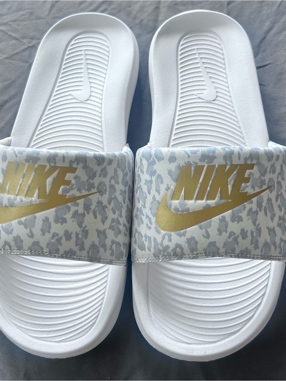 Nike White Slide Sandals with Gold Logo Accent